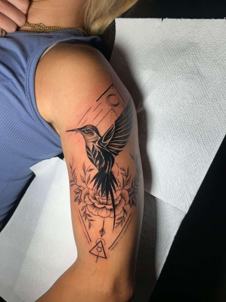 Detailed phoenix bird tattoo on upper arm done at Tinta y Pinta Tattoo Quito